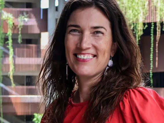 Amy Jorgensen smiles in a red blouse at the ENR2 building.