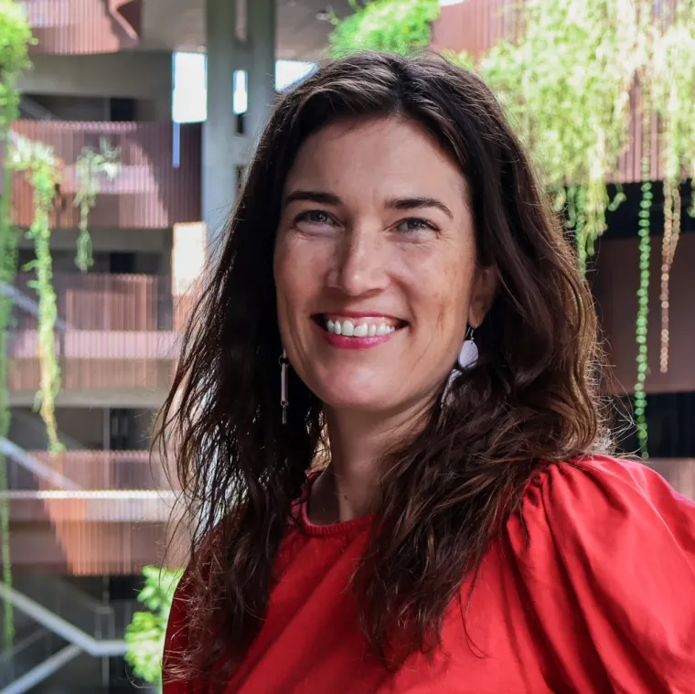 Amy Jorgensen smiles in a red blouse at the ENR2 building.