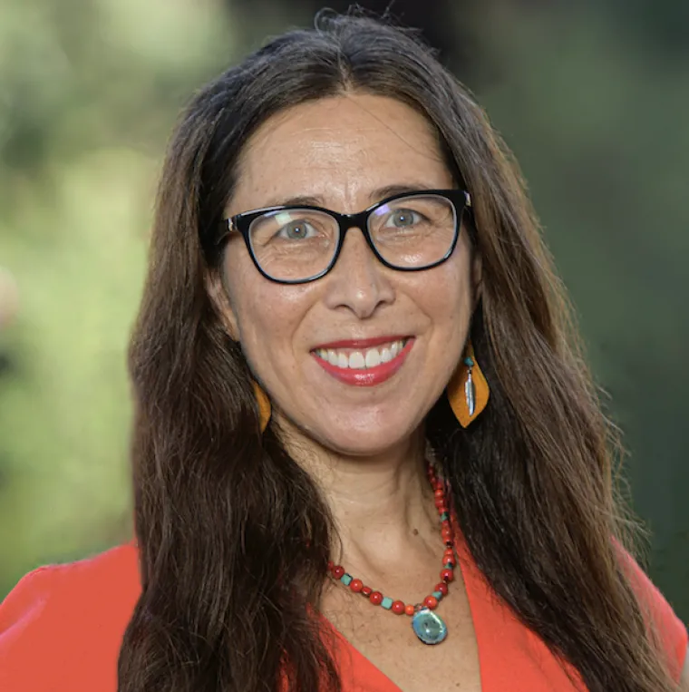 Stephanie Russo Carroll outdoor portrait in a red-orange blouse