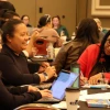 Attendees work as a group during an IDSov Summit session.